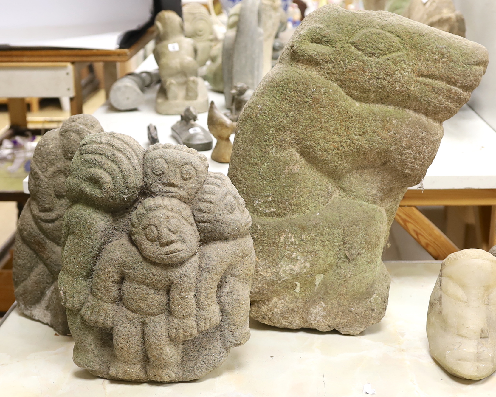 Three weathered Shona stone carvings, 1960s-70s; a figurative group, a figure and an animal, tallest 50cm